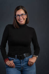 a headshot of a coach wearing black
