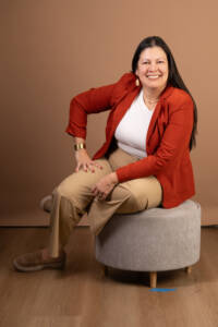 a headshot a of a business owner with beige backdrop